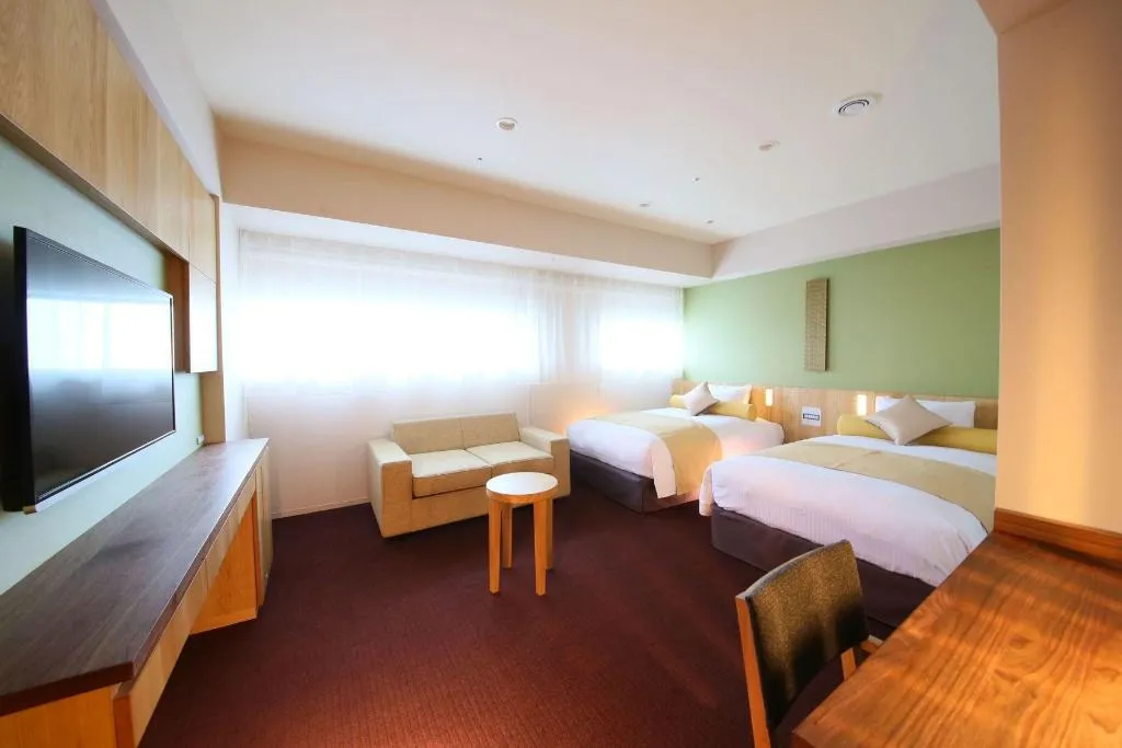 Example room at Hotel Gracery Shinjuku with two beds and window seating